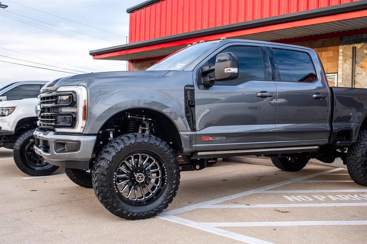 Lifted gray Ford F-250 Platinum on mud tires and aftermarket wheels