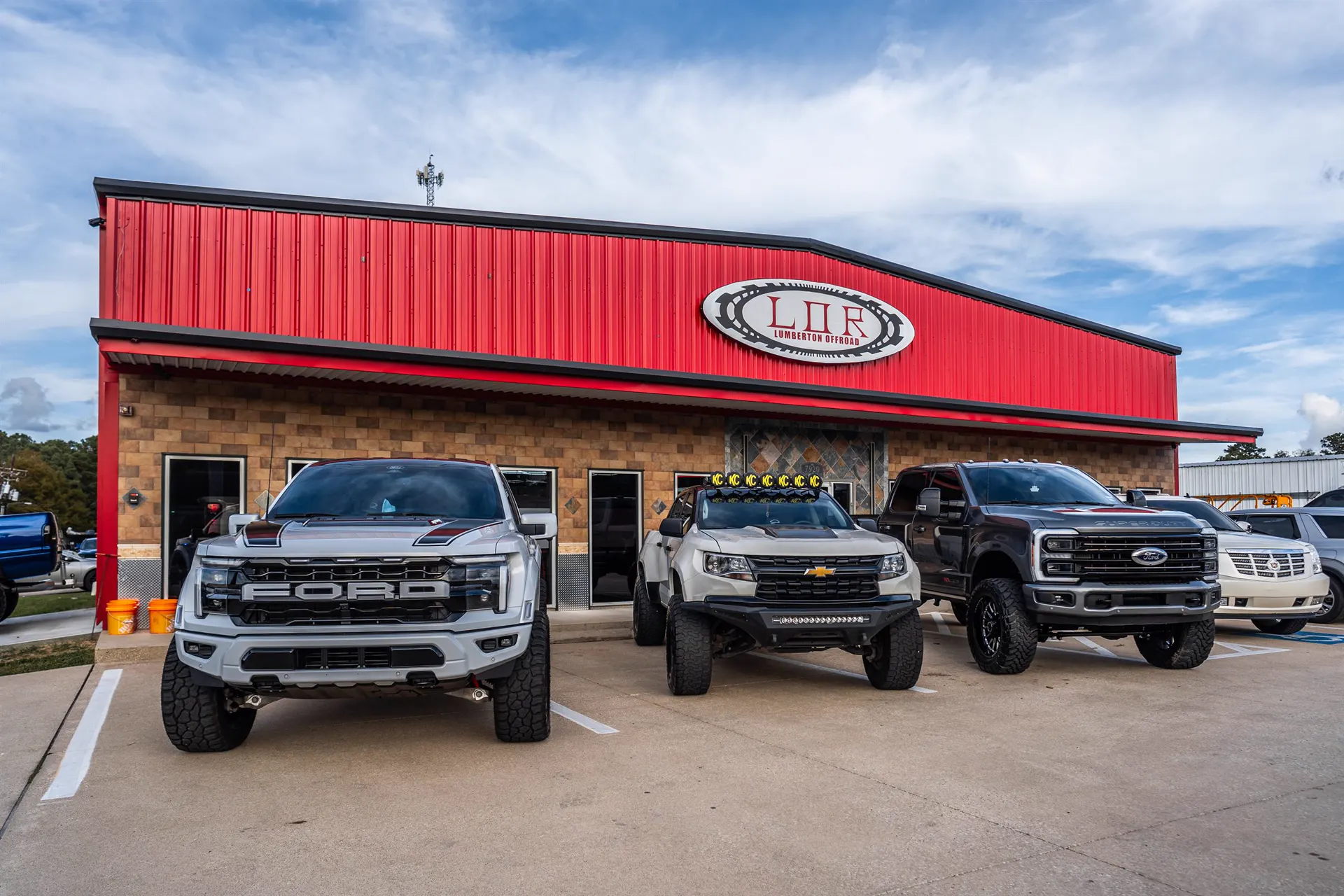 Lifted trucks in front of Lumberton Offroad